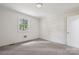 A well-lit bedroom features neutral carpet, a window, and white paneled walls at 613 Davis St, Lancaster, SC 29720