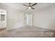 This bedroom offers neutral carpet, a modern ceiling fan, and convenient access to the bathroom at 613 Davis St, Lancaster, SC 29720