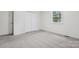 The bedroom includes neutral carpet, a window, and a closet for storage at 613 Davis St, Lancaster, SC 29720