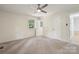 This bedroom features neutral carpet, natural light, and a modern ceiling fan at 613 Davis St, Lancaster, SC 29720
