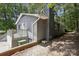View of the back of a gray house with a brick chimney and a small deck at 613 Davis St, Lancaster, SC 29720