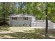 View of the home's exterior, showcasing the charming front yard and lush surroundings at 613 Davis St, Lancaster, SC 29720
