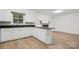 An expansive kitchen with white cabinets and a cozy fireplace at 613 Davis St, Lancaster, SC 29720