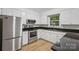 Updated kitchen featuring stainless steel appliances, modern countertops, and white cabinets at 613 Davis St, Lancaster, SC 29720