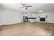Open-concept living space with modern ceiling fan, brick fireplace, and hardwood flooring at 613 Davis St, Lancaster, SC 29720