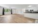 Bright living room featuring a hardwood floor, ceiling fan, and open kitchen concept at 613 Davis St, Lancaster, SC 29720