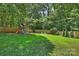 Green backyard featuring wooden playset surrounded by a classic wooden fence at 6150 Rocky Falls Rd, Charlotte, NC 28211