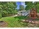 View of the backyard featuring a play set and basketball court perfect for outdoor activities and Gathering fun at 6150 Rocky Falls Rd, Charlotte, NC 28211