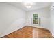 Bright bedroom with hardwood floors, natural light, and a spacious closet at 6150 Rocky Falls Rd, Charlotte, NC 28211