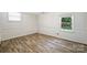 Cozy bedroom with wood floors, white walls, and plenty of natural light at 6150 Rocky Falls Rd, Charlotte, NC 28211