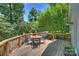 Elevated wooden deck with outdoor seating surrounded by lush trees at 6150 Rocky Falls Rd, Charlotte, NC 28211