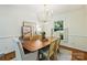 Bright dining room with modern chandelier, hardwood floors, and views of the outdoors at 6150 Rocky Falls Rd, Charlotte, NC 28211