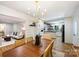 Open-concept dining area leading into a modern kitchen and a comfortable living room at 6150 Rocky Falls Rd, Charlotte, NC 28211