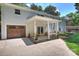 Rear view of the home with covered patio, large garage, and plenty of outdoor living space at 6150 Rocky Falls Rd, Charlotte, NC 28211