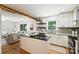 Stylish kitchen with white cabinets, granite countertops, island, and seamless flow to the living area at 6150 Rocky Falls Rd, Charlotte, NC 28211