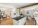 Open-concept kitchen featuring an island with seating, modern appliances, and views of the dining and living spaces at 6150 Rocky Falls Rd, Charlotte, NC 28211