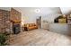 Inviting living room with a brick fireplace, modern flooring, and a built-in bar area at 6150 Rocky Falls Rd, Charlotte, NC 28211