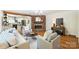 Inviting living room with brick fireplace, hardwood floors, and neutral decor next to a kitchen at 6150 Rocky Falls Rd, Charlotte, NC 28211