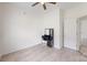 Simple bedroom features light wood-look floors and a vanity with lighted mirror at 6825 Woodleaf Rd, Woodleaf, NC 27054