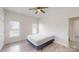 Bright bedroom featuring neutral walls, wood-look flooring, and natural light at 6825 Woodleaf Rd, Woodleaf, NC 27054