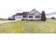 Charming single-story home with well-maintained lawn and attached two-car garage at 6825 Woodleaf Rd, Woodleaf, NC 27054