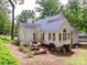 A cozy backyard featuring a brick patio with outdoor seating and a well-maintained lawn at 6934 Loretta Pl, Charlotte, NC 28215