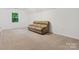 Spacious carpeted bonus room with a comfortable couch and natural lighting at 6934 Loretta Pl, Charlotte, NC 28215
