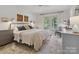 Bright bedroom featuring a walkout balcony and a decorative carpet at 6934 Loretta Pl, Charlotte, NC 28215