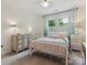 Charming bedroom with white iron bed frame, coordinated bedding, and bright natural light at 6934 Loretta Pl, Charlotte, NC 28215
