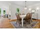 Bright dining room with hardwood floors and a stylish carpet at 6934 Loretta Pl, Charlotte, NC 28215