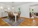 Bright dining room with hardwood floors and a stylish carpet at 6934 Loretta Pl, Charlotte, NC 28215