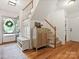 Bright foyer featuring hardwood floors, stylish furnishings, staircase, and ample natural light at 6934 Loretta Pl, Charlotte, NC 28215