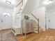 Bright foyer featuring hardwood floors, stylish furnishings, staircase, and ample natural light at 6934 Loretta Pl, Charlotte, NC 28215