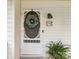 Close up of the home's inviting front door with decorative wreath, stylish light fixture, and house number at 6934 Loretta Pl, Charlotte, NC 28215
