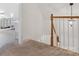 Hallway with carpeted stairs and view into the main bedroom at 6934 Loretta Pl, Charlotte, NC 28215