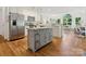Bright open kitchen with an island, hardwood floors and stainless steel appliances at 6934 Loretta Pl, Charlotte, NC 28215