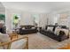 Spacious living room filled with natural light, comfortable seating, and hardwood floors at 6934 Loretta Pl, Charlotte, NC 28215