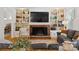 Inviting living room with a cozy fireplace, built-in bookshelves, and comfortable seating at 6934 Loretta Pl, Charlotte, NC 28215