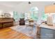 Bright and airy living room with a vaulted ceiling, large windows, and hardwood floors at 6934 Loretta Pl, Charlotte, NC 28215
