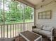 Relaxing screened-in patio with comfortable seating and view of the lush greenery surrounding the property at 6934 Loretta Pl, Charlotte, NC 28215