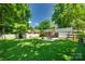 Expansive backyard with lush green grass, patio, shed and fenced perimeter at 7026 Tabor Ln, Charlotte, NC 28211
