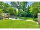Large backyard with a well-manicured lawn, patio, and mature trees, offering ample space at 7026 Tabor Ln, Charlotte, NC 28211
