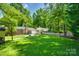 A large, beautifully landscaped backyard with a patio and convenient storage shed at 7026 Tabor Ln, Charlotte, NC 28211