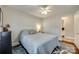 Cozy bedroom with a view to the ensuite bath, neutral colors, and hardwood floors at 7026 Tabor Ln, Charlotte, NC 28211