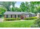 Charming brick home with a well-manicured lawn and lush landscaping at 7026 Tabor Ln, Charlotte, NC 28211