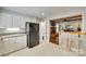 Kitchen with white cabinets, stone countertops, and an open view to the living room at 7026 Tabor Ln, Charlotte, NC 28211