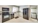 Updated kitchen with black appliances, white cabinets, and a view into the laundry area at 7026 Tabor Ln, Charlotte, NC 28211