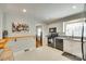 Bright kitchen featuring modern black appliances, white cabinets, and a breakfast bar area at 7026 Tabor Ln, Charlotte, NC 28211