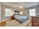 Serene main bedroom with ample natural light and hardwood floors complemented by neutral tones at 7026 Tabor Ln, Charlotte, NC 28211