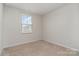 Empty bedroom featuring a window, carpet flooring and neutral paint at 706 Dillon Way, Fort Mill, SC 29715